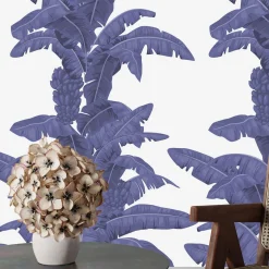 Carta da parati blu con foglie tropicali