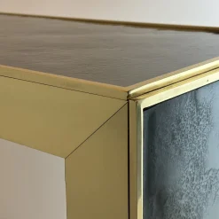 Console Materia con telaio in oro e piano in vetro fumé