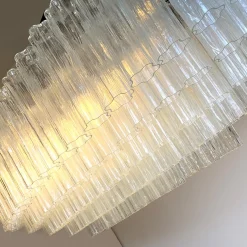 Lampadario ovale Tronchi con struttura in metallo brunito e vetro di Murano