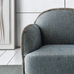 Poltrona Ada in tessuto azzurro e piping di Paola Navone