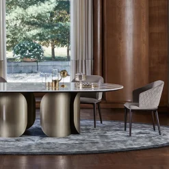 Tavolo da pranzo Oscar con base ovale in bronzo e top in marmo Calacatta Oro